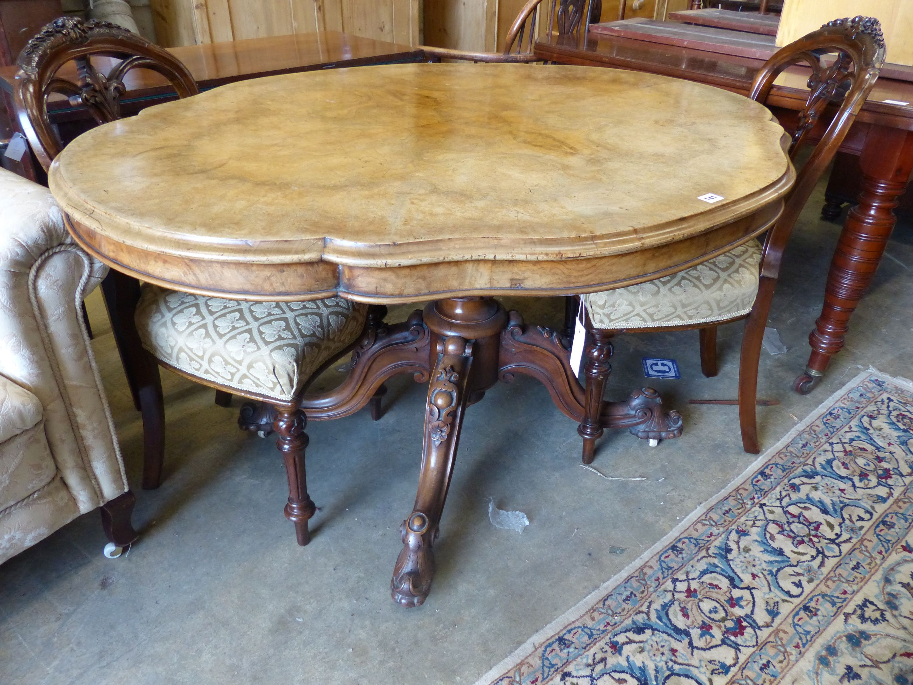 A Victorian figured walnut shaped oval tilt topped loo table, width 134cm, depth 102cm, height 73cm